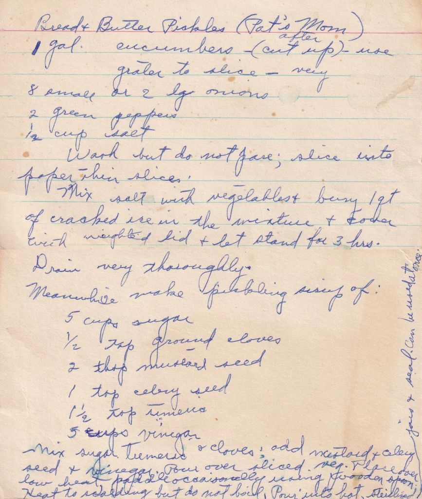 Bread and butter pickles recipe handwritten on lined paper with cucumbers, onions, peppers, and spiced vinegar syrup