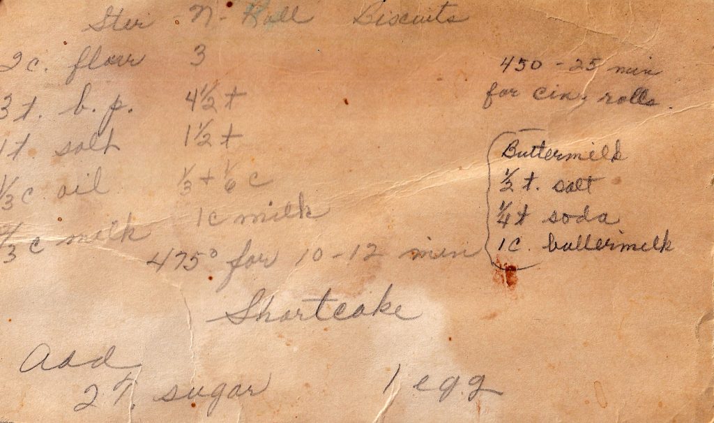 Handwritten Stir-N-Roll Biscuits recipe card with faded pencil notes and baking variations.